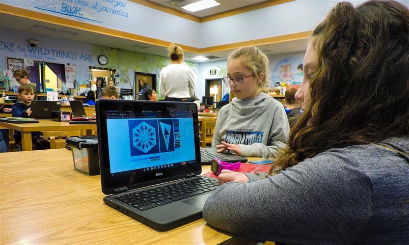 Students on laptops in the library